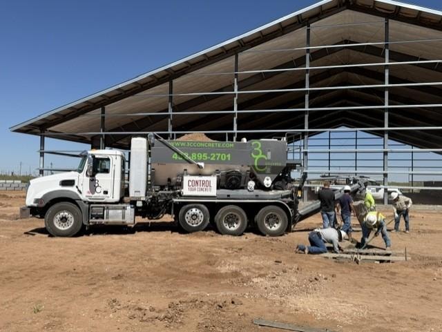 Concrete truck and crew working at commercial construction site
